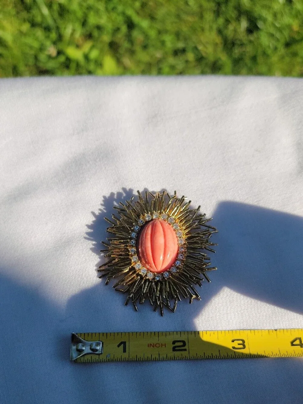 Vintage Joan Rivers Gold Sunburst Brooch with Coral Center